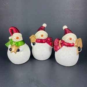 A Trio of Cute and Colorful Hand Painted Ceramic Snowmen in Festive Attire.